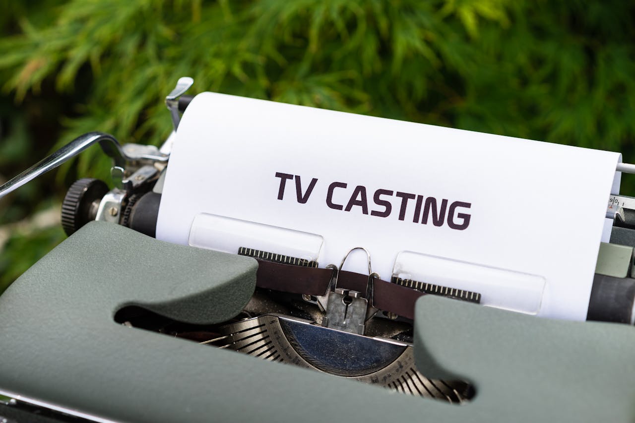 Close-up of a vintage typewriter with a sheet saying TV Casting, emphasizing the concept of scriptwriting.